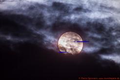 Weißlicht-Aufnahme der Sonne mit vorüberziehendem Merkur hinter atmosphärischen Wolken (München), 500mm Brennweite